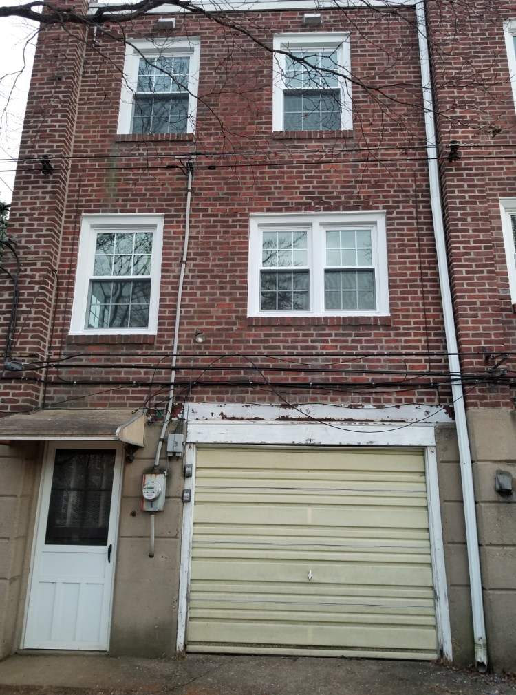 Rear view of the home. New windows and garage door.